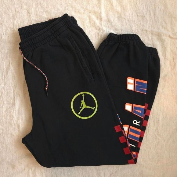 Jordan black joggers with orange and red accents